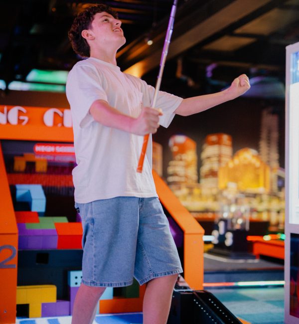 Indoor mini golf at Play It Southbank Melbourne, guest celebrating a winning put