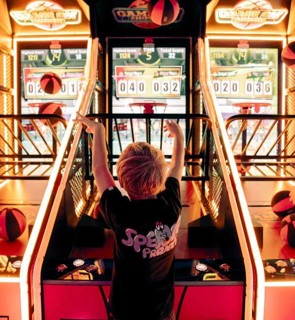 Kids playing arcade basketball games at Play It Southbank Melbourne