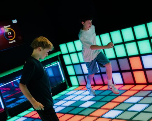 Kids playing Grid Rush interactive floor game at Play It Southbank Melbourne